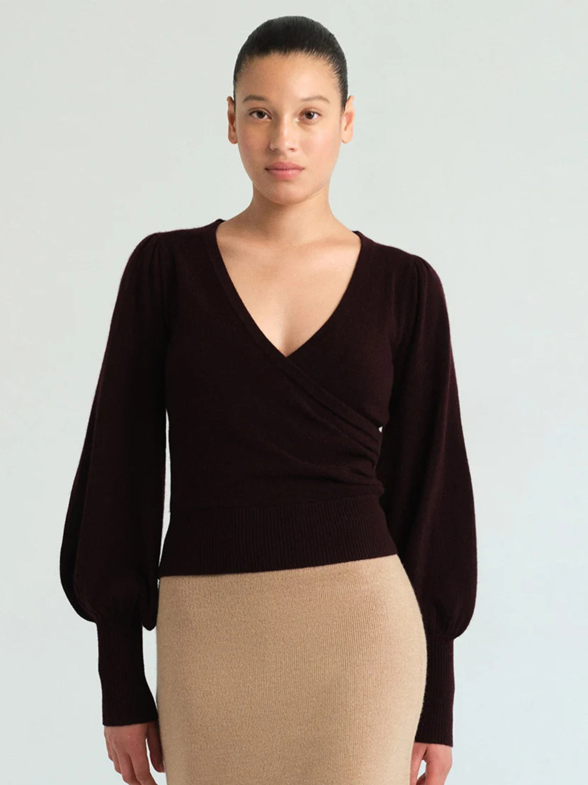 Front view of Cara Cara Ezra Merlot top on a model, showing gathered wrap-effect neckline and full sleeves.