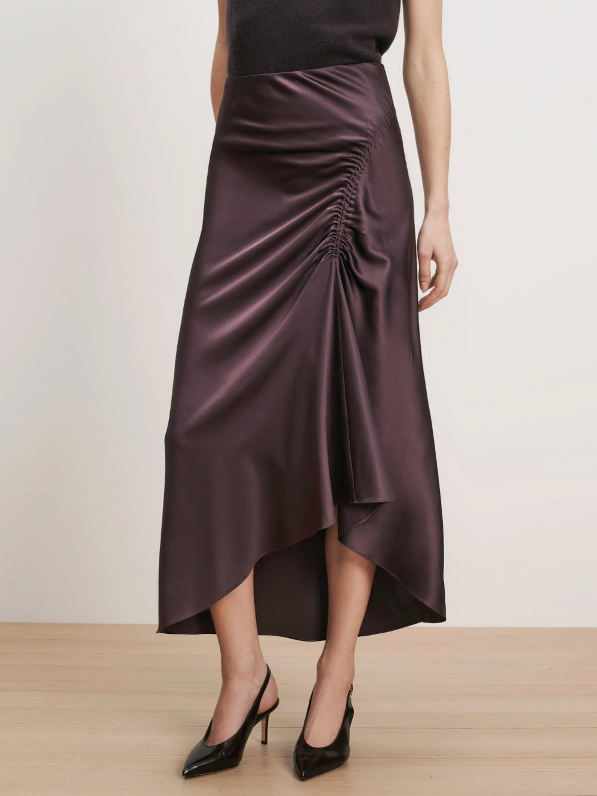 Close-up of the Veronica Beard Felecia Dark Eggplant skirt's ruching and curved hem