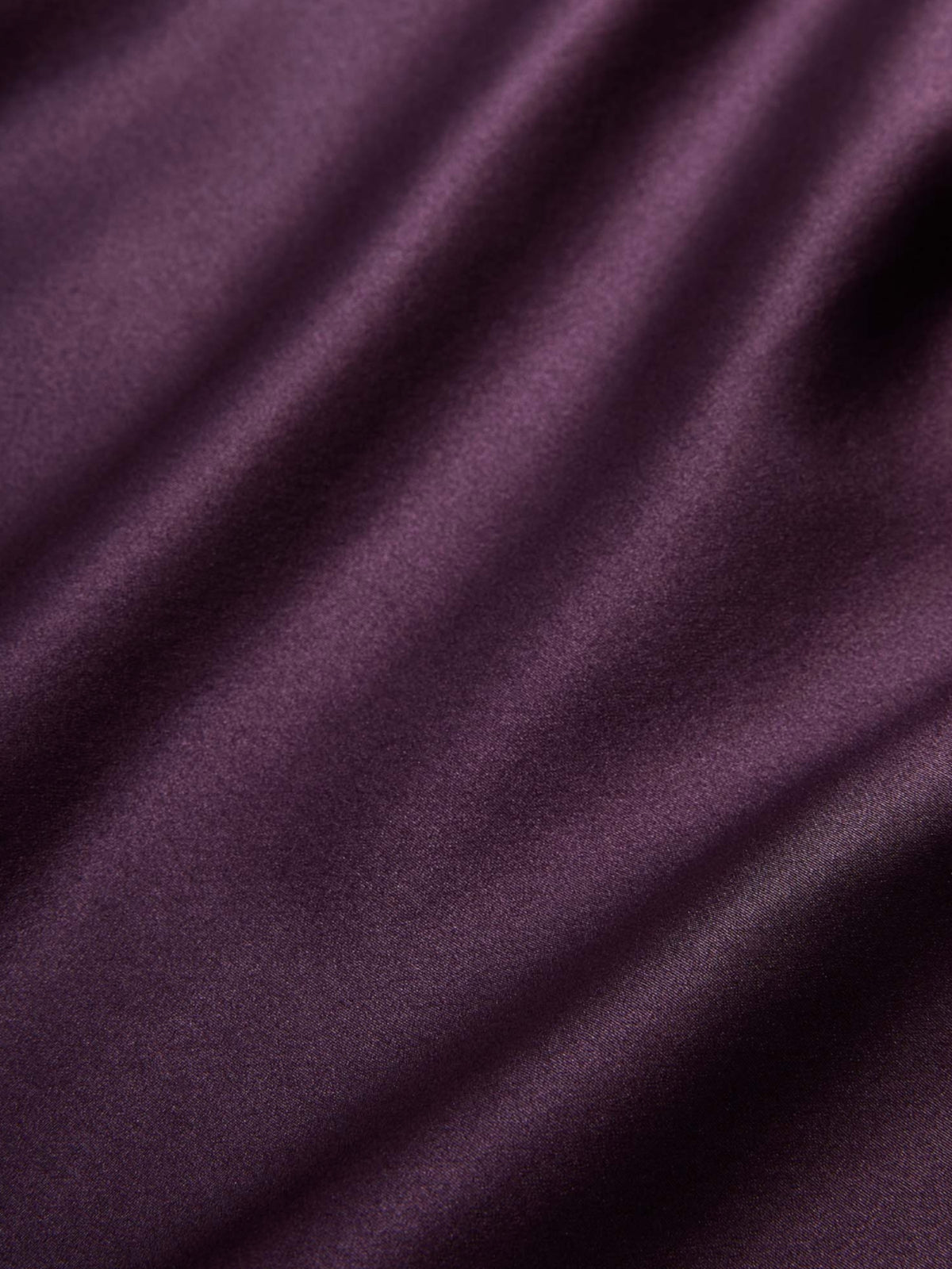 Close-up of the Veronica Beard Tam Dark Eggplant blouse's fabric folds and sheen