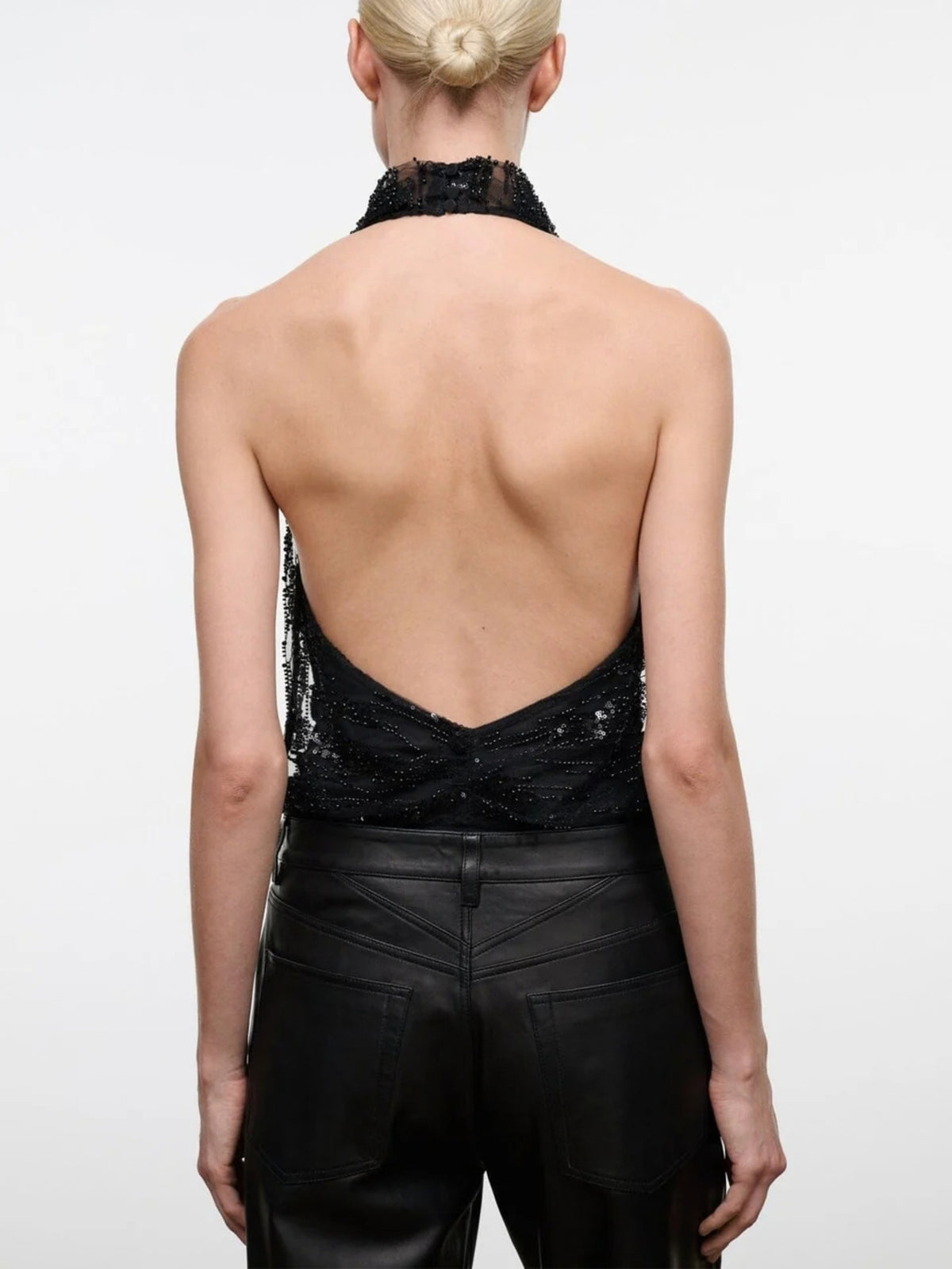 Back view of the STAUD Monay Black Beaded bodysuit, showing the halter neck and low open back