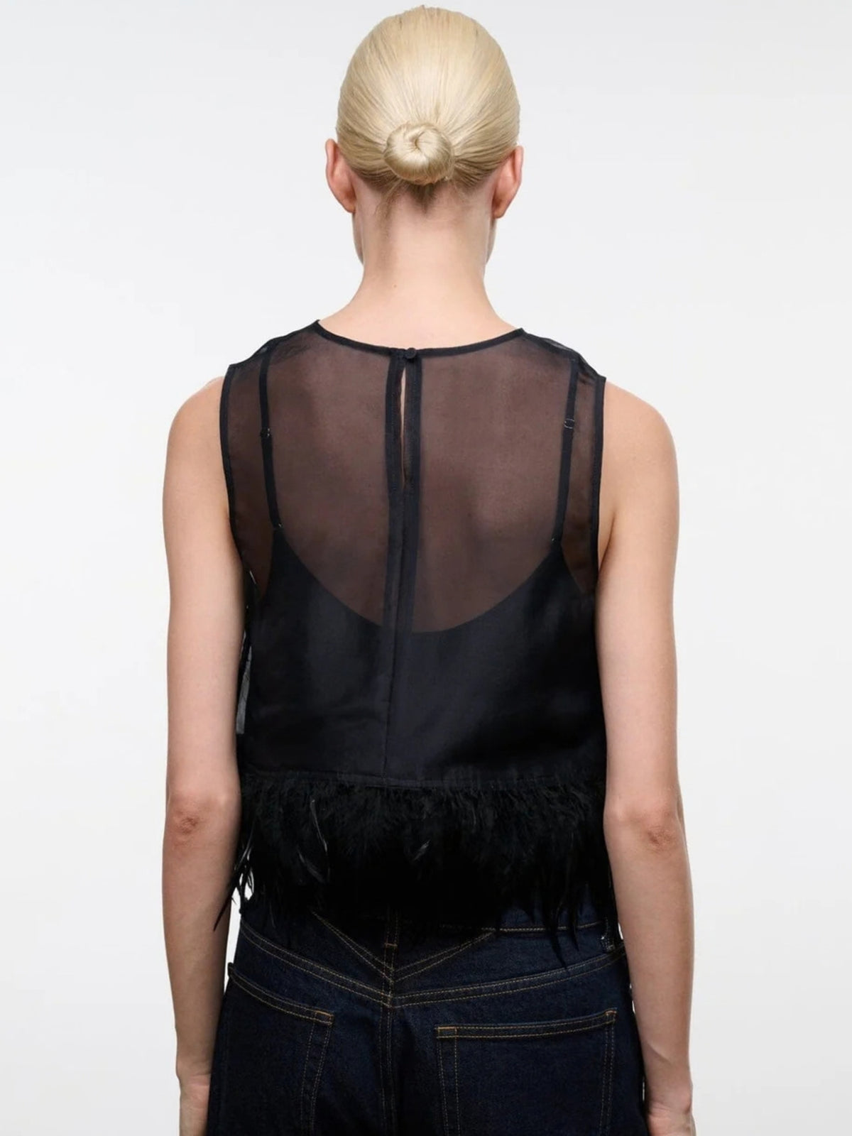 Back view of the STAUD Avi Black top, showing the sheer panel and center-back closure