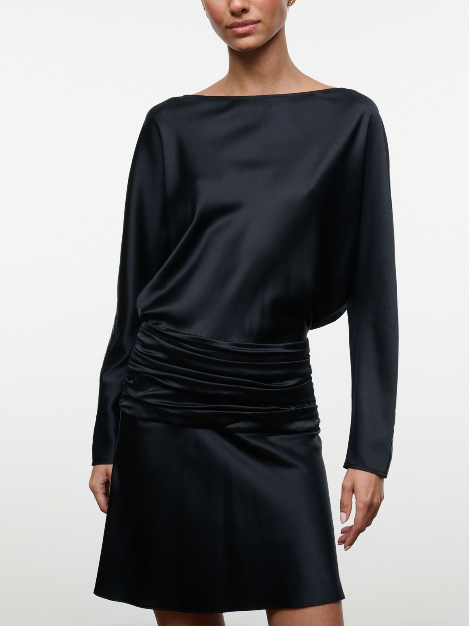Close-up of black Staud Freda Silk Mini Dress showing boat neckline, draped bodice and ruched waist