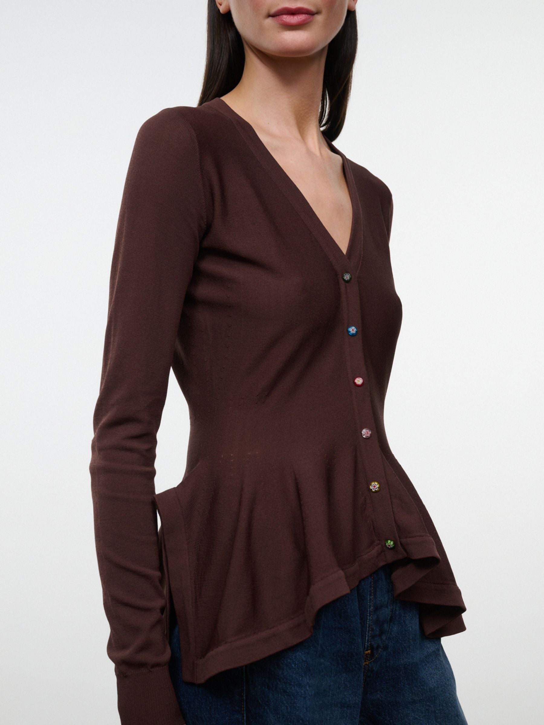 Close-up of Staud Jamie Top in Earth showing V-neck, multicolor flower buttons and peplum