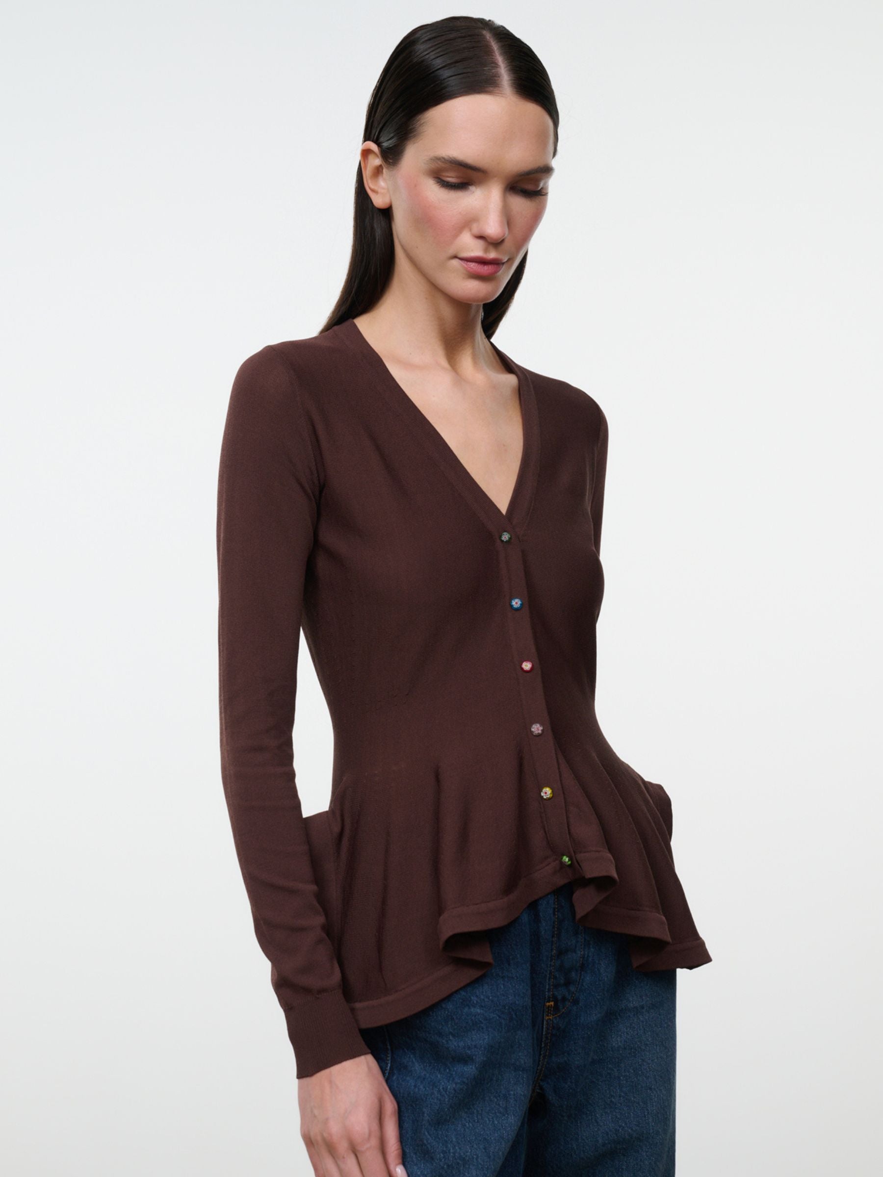 Staud Jamie Top in Earth on model, close front view showing V-neck, flower buttons and peplum hem