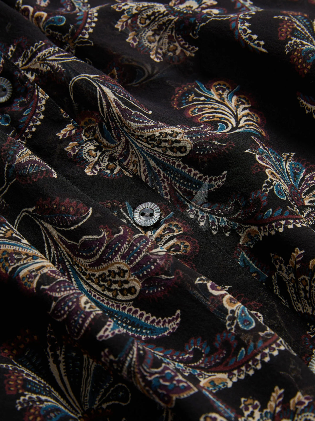 Close-up of the Veronica Beard Ashlynn Black Multi blouse's paisley print and button