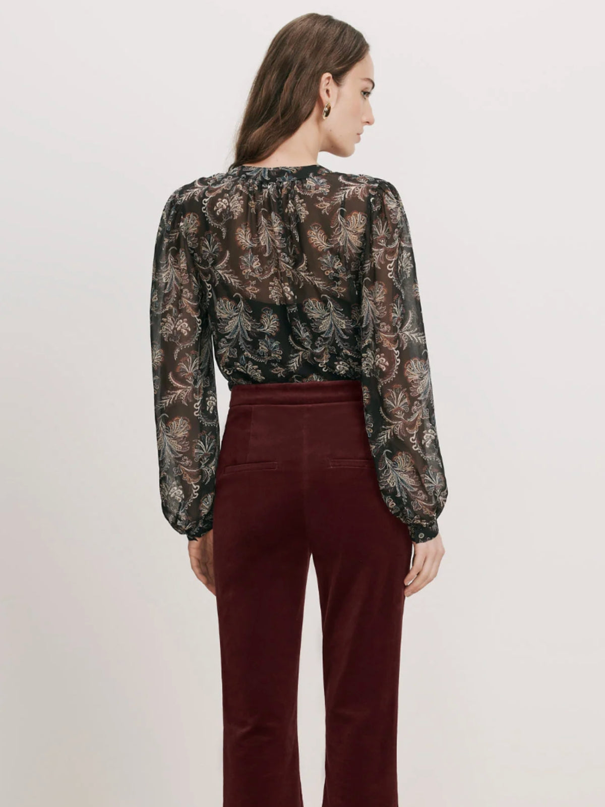 Back view of the Veronica Beard Ashlynn Black Multi printed blouse tucked into burgundy pants