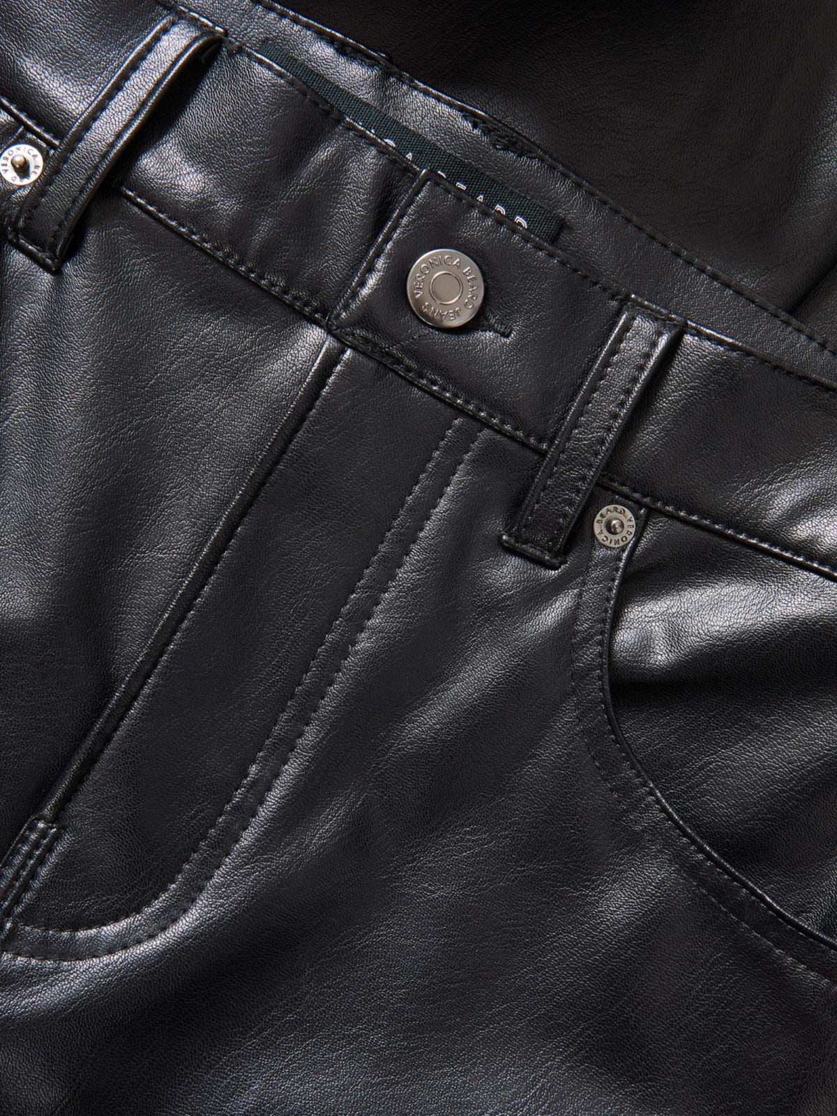Close-up of the Veronica Beard Beverly black pants' waistband, button, belt loops and front pocket