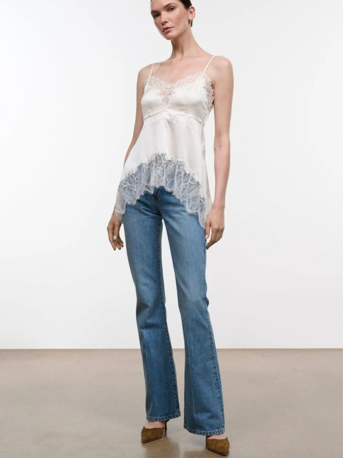 STAUD Lina Ivory silk top styled with blue jeans, full-length front view