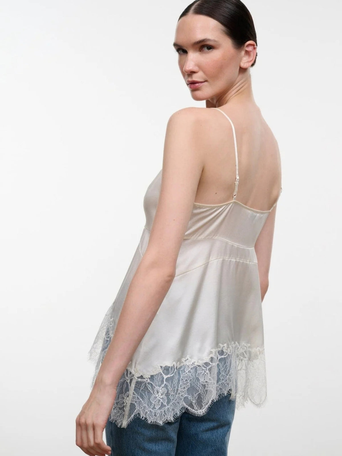Back view of the STAUD Lina Ivory silk top, showing thin straps and a lace-trimmed hem