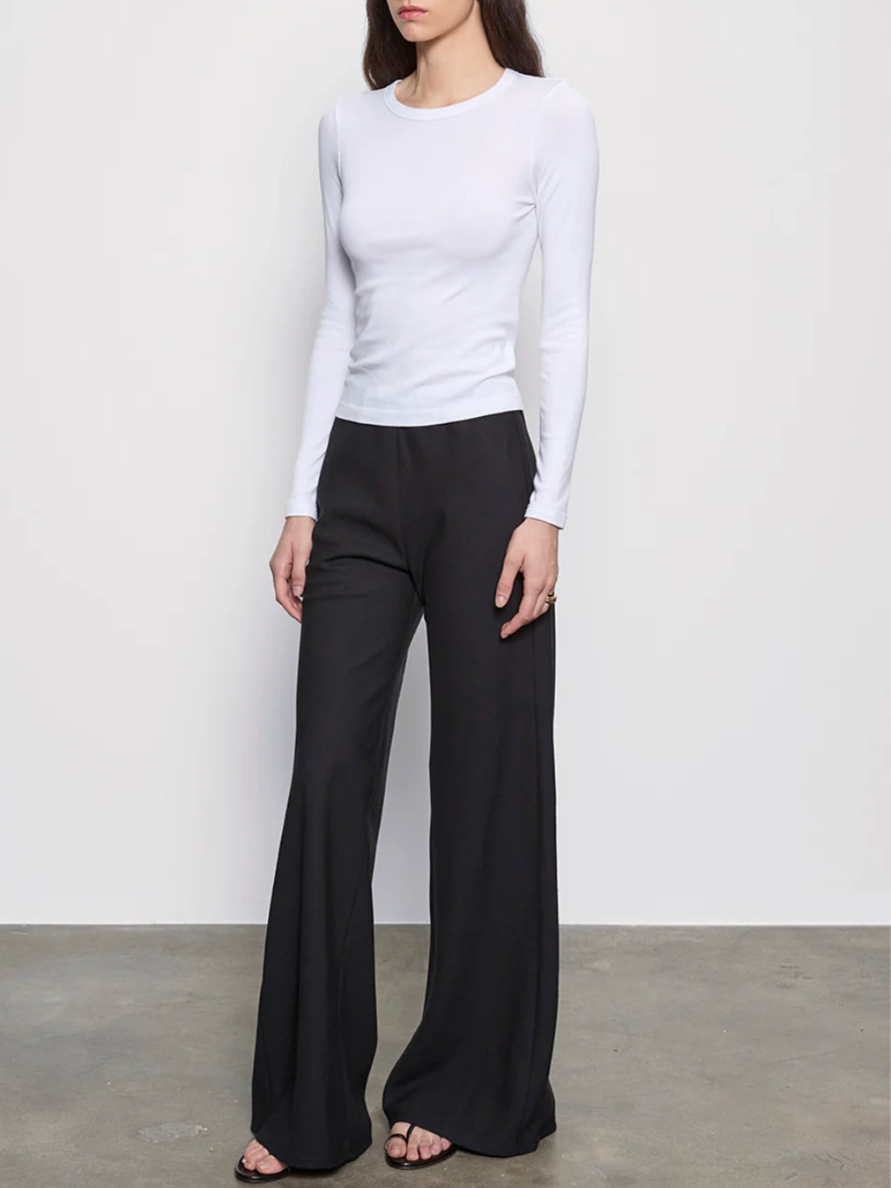 Full-length front view of model wearing Enza Costa Supima Cotton New Classic Long-Sleeve Tee in white