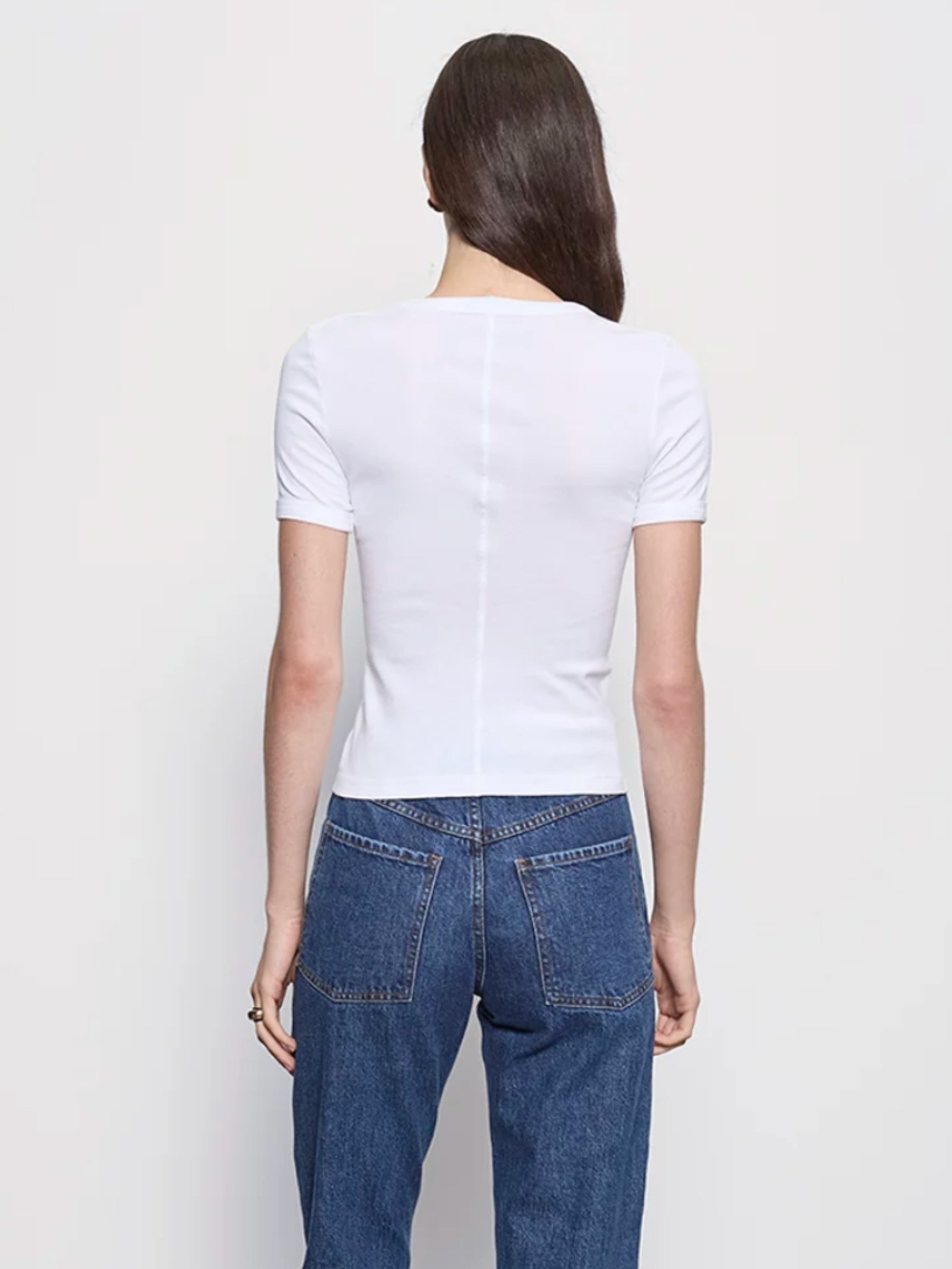 Enza Costa Supima Cotton Perfect Tee in white on model with jeans, back view