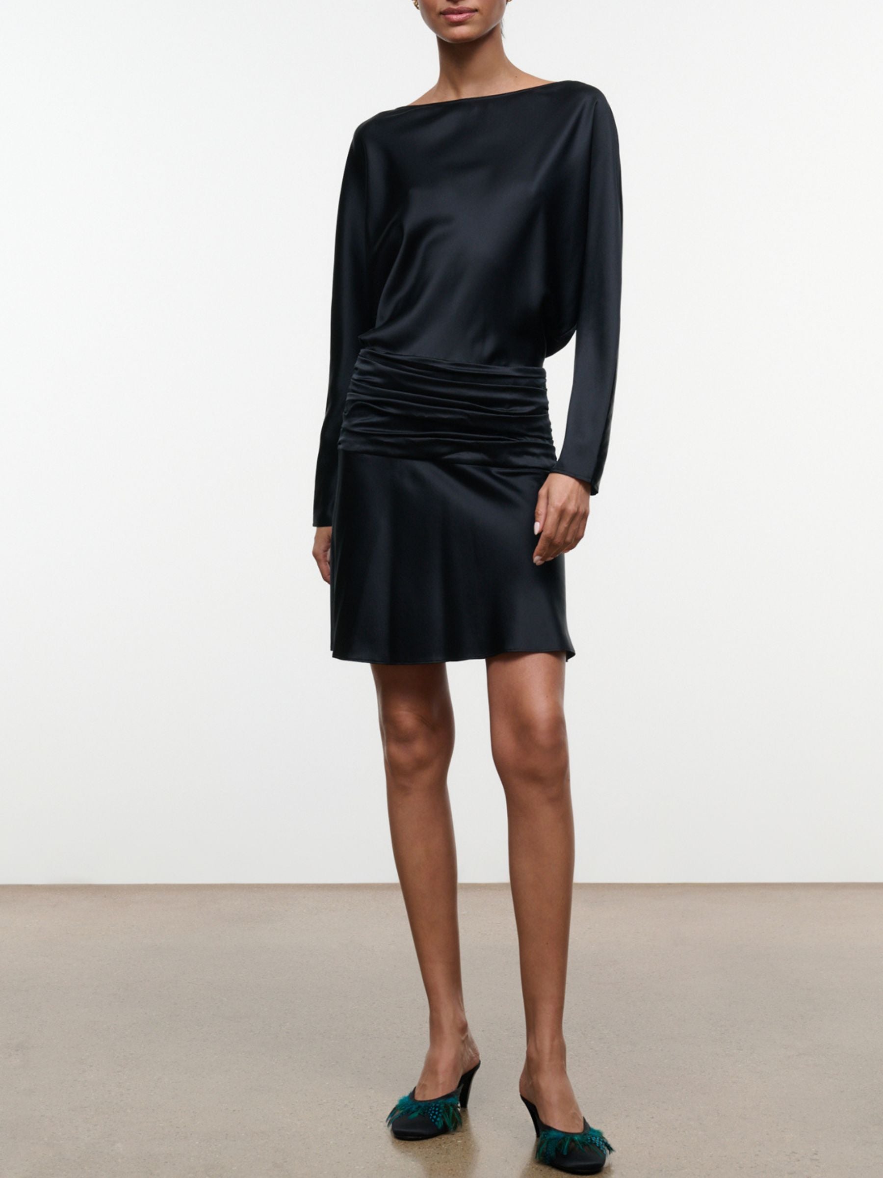 Model wearing black Staud Freda Silk Mini Dress with long sleeves and ruched waist, front view