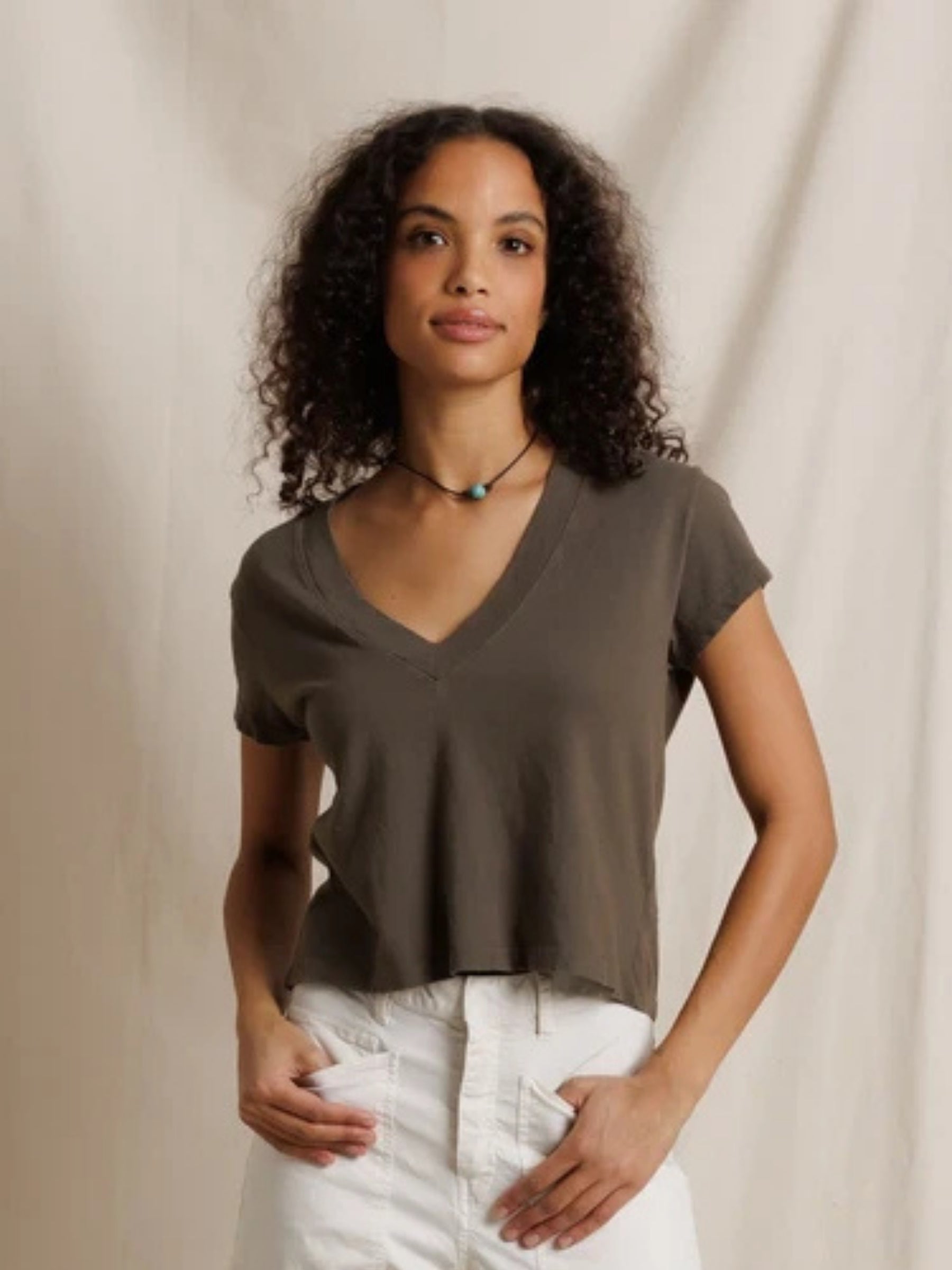 Model wearing the Perfect White Tee Alanis V-Neck Tee in Dark Olive, front view