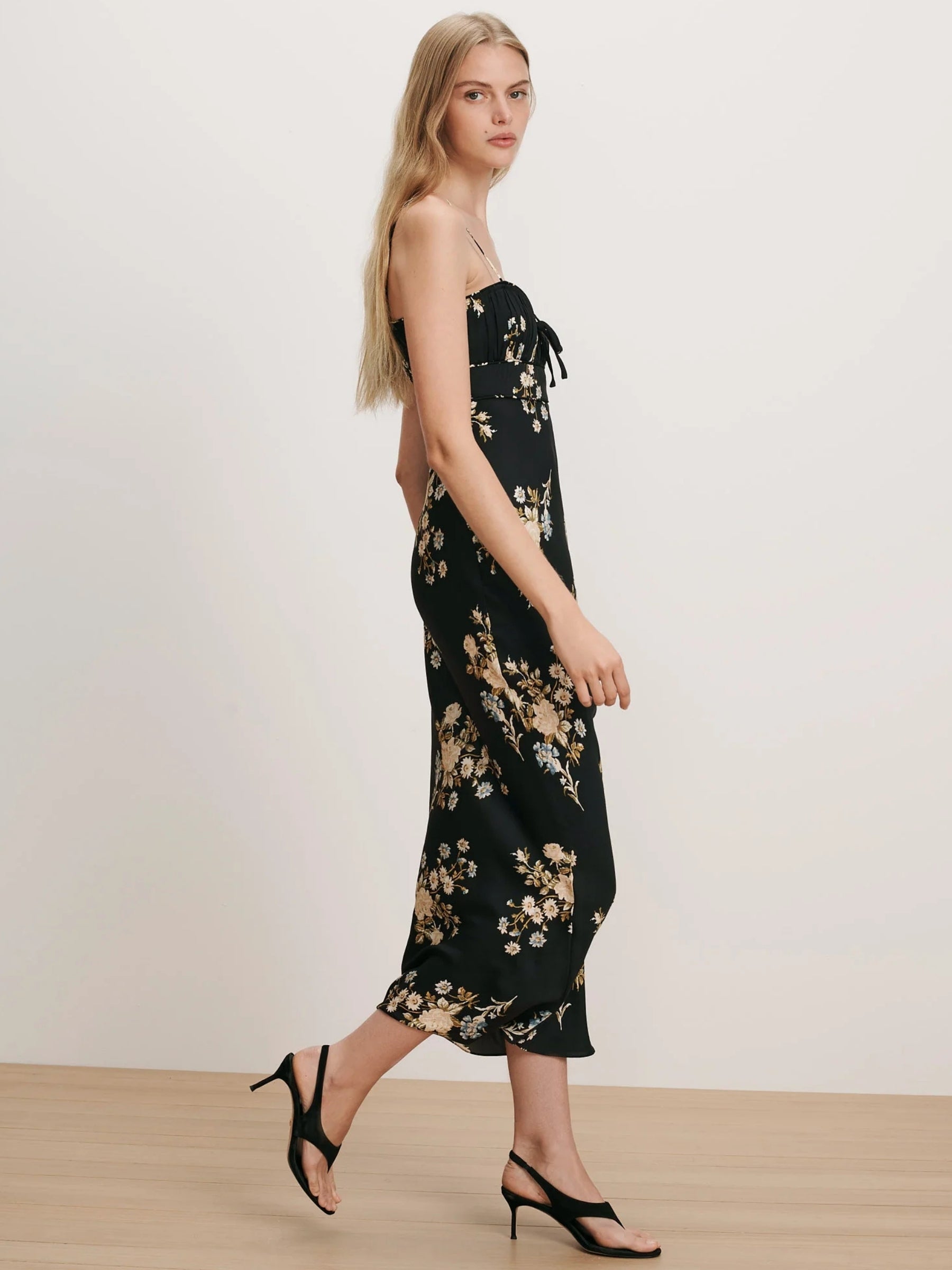 Model wearing the Veronica Beard Kieren Floral Slip Dress in Black Multi, three-quarter view
